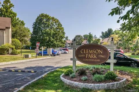 Tree-lined entrance drive and welcome sign at Clemson Park