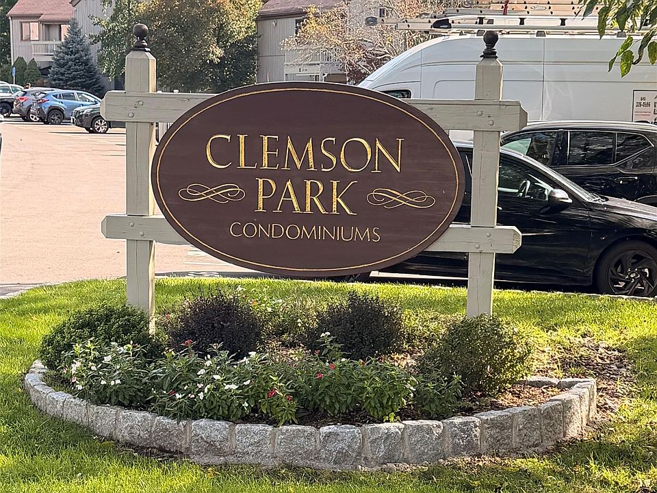 Clemson Park’s burgundy and gold entrance sign surrounded by flowers and landscaped grounds